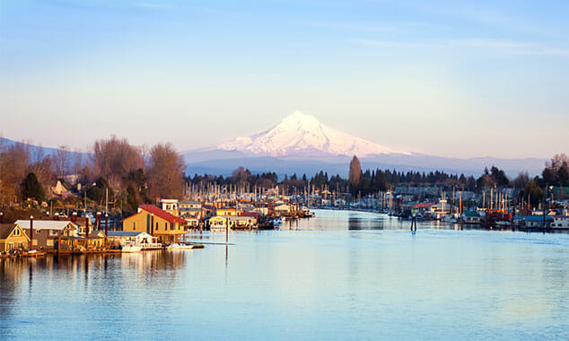 floating homes on river with Mt Hood in background