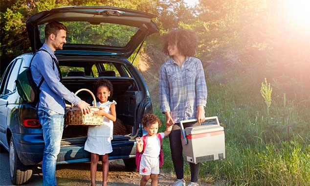 family unpacking car for a picnic