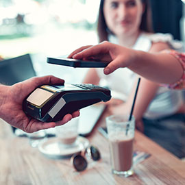 woman paying with a mobile wallet
