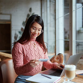 Woman using laptop and credit card