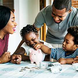 family filling a piggy bank