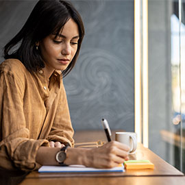 woman sitting at desk doing paperwork